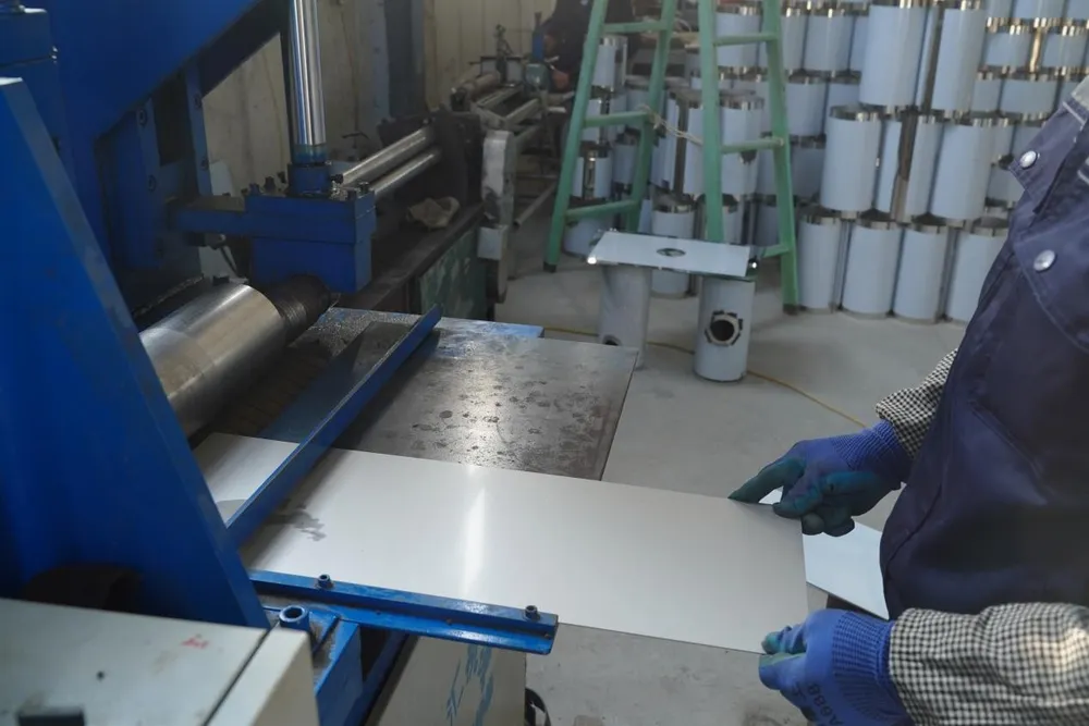 Two-Roll Plate Bending Machine for forming the cylindrical drum of valve mufflers.